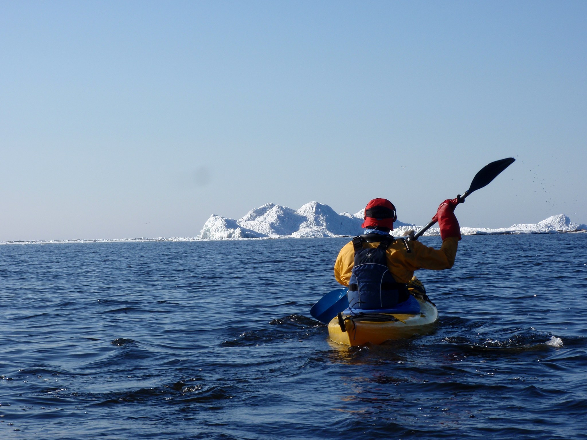 Person paddling among blogs of ice in Raahe 