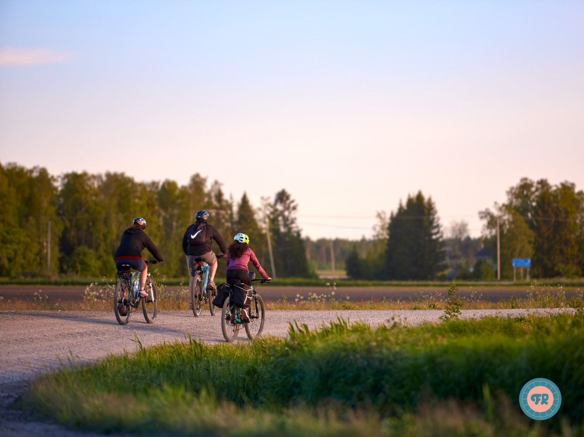 Cyclists riding on the dirt road.